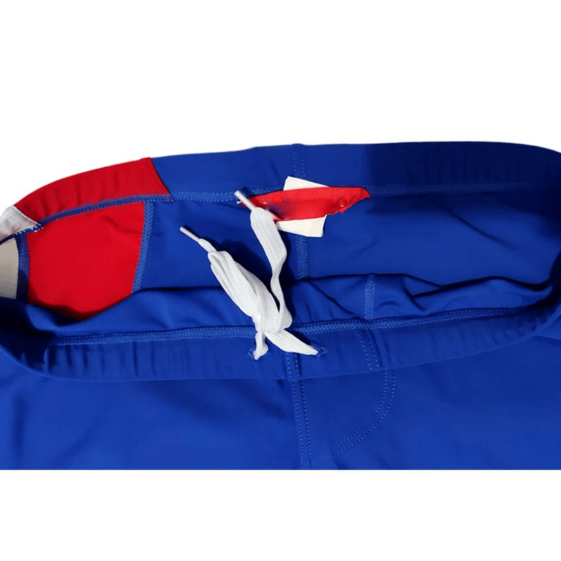 Close-up of men's compression quick-drying tights with a blue and red patchwork design, featuring a white drawstring waistband.