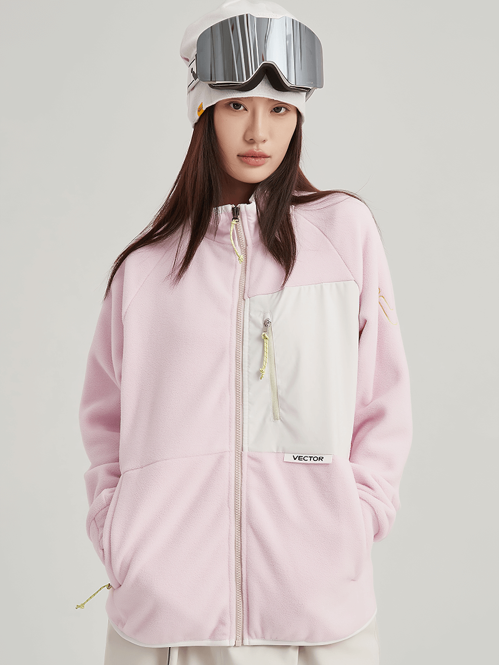 Woman wearing pink contrast full-zip fleece jacket with zip pocket, perfect for skiing and outdoor activities. Warm polyester fabric.