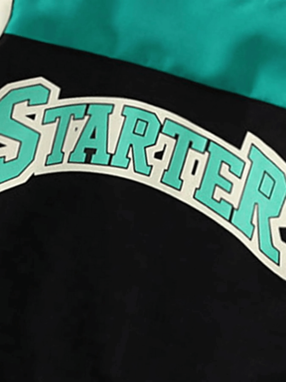 Kids varsity jacket close-up with bold "STARTER" lettering and star print on sleeves, perfect for trendy, casual outings.