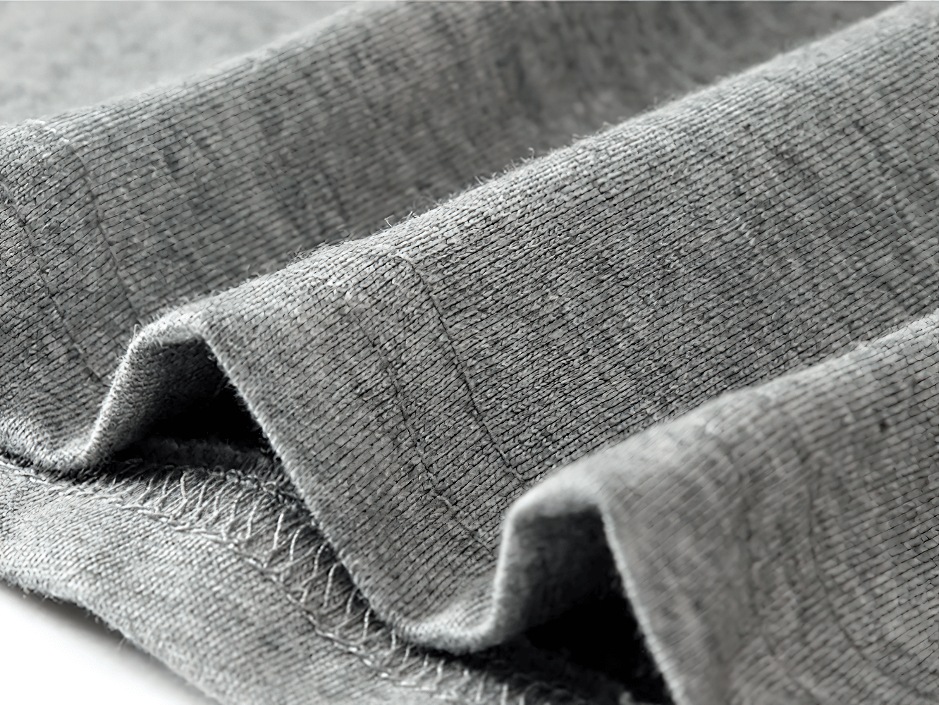 Close-up of soft gray cotton fabric with visible stitching, showcasing quality and comfort of the Forever Young long-sleeve top.