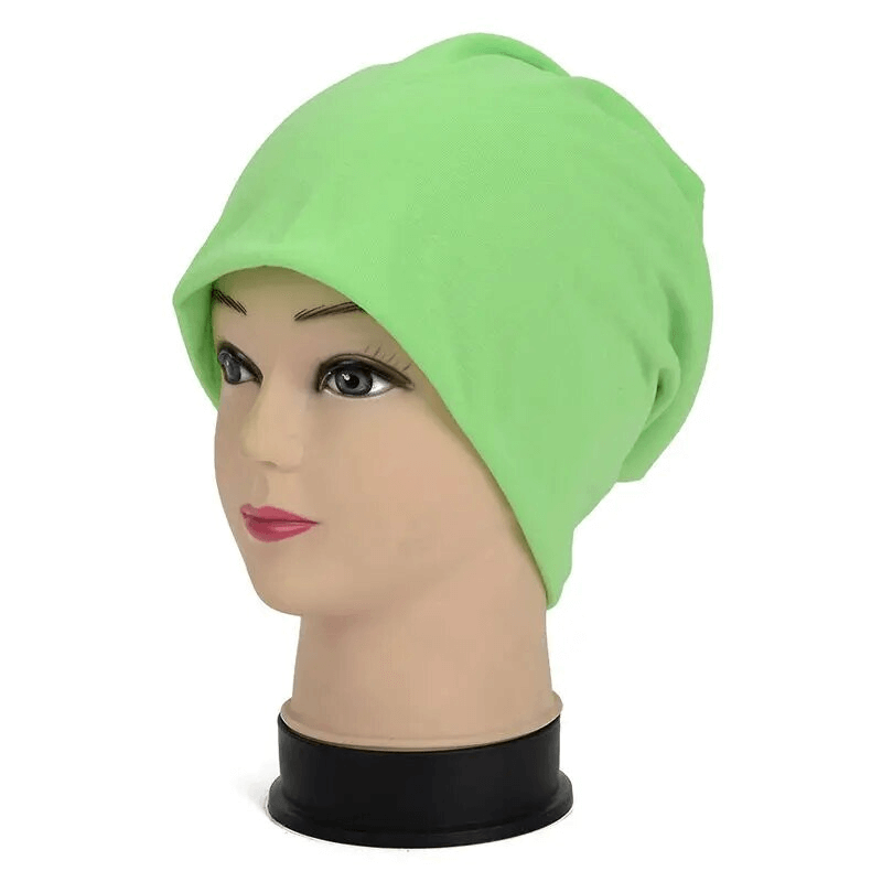 Lime green cotton soft lightweight slouchy beanie for running on mannequin; unisex and casual, ideal for outdoor activities.