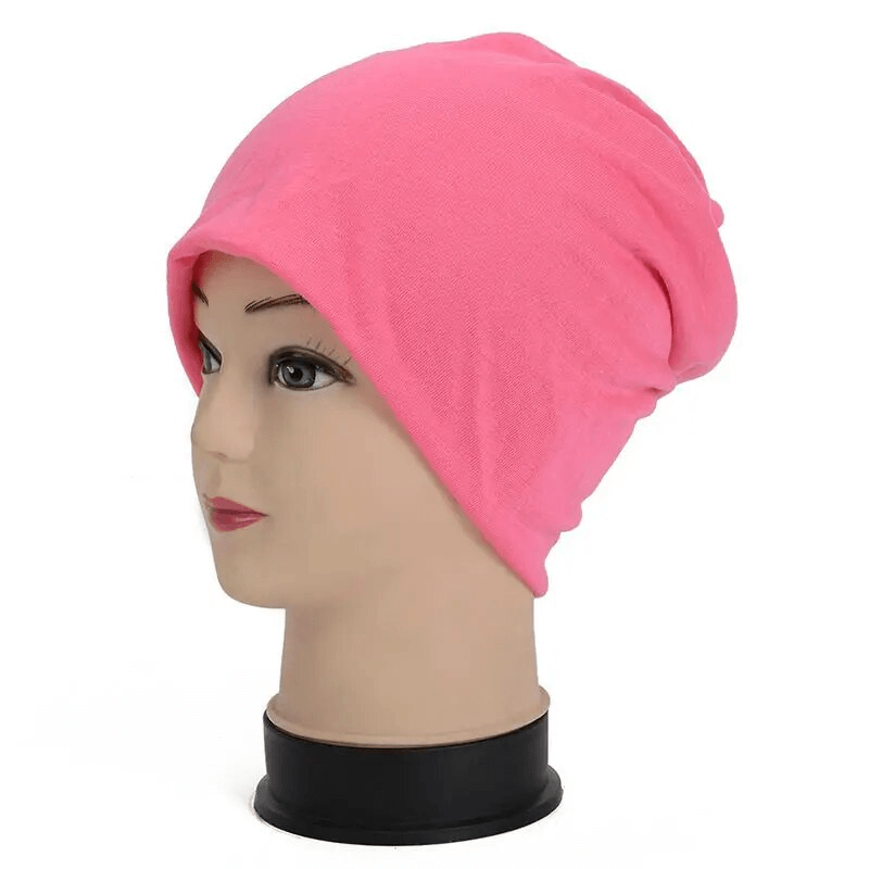 Pink cotton slouchy beanie on mannequin, perfect for running and outdoor activities, unisex, casual style, warmth and comfort in one size.