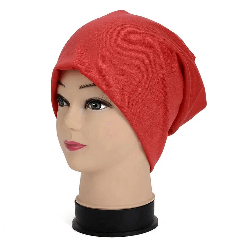 Red cotton lightweight slouchy beanie for running on a mannequin, unisex design, perfect for outdoor activities, casual style.