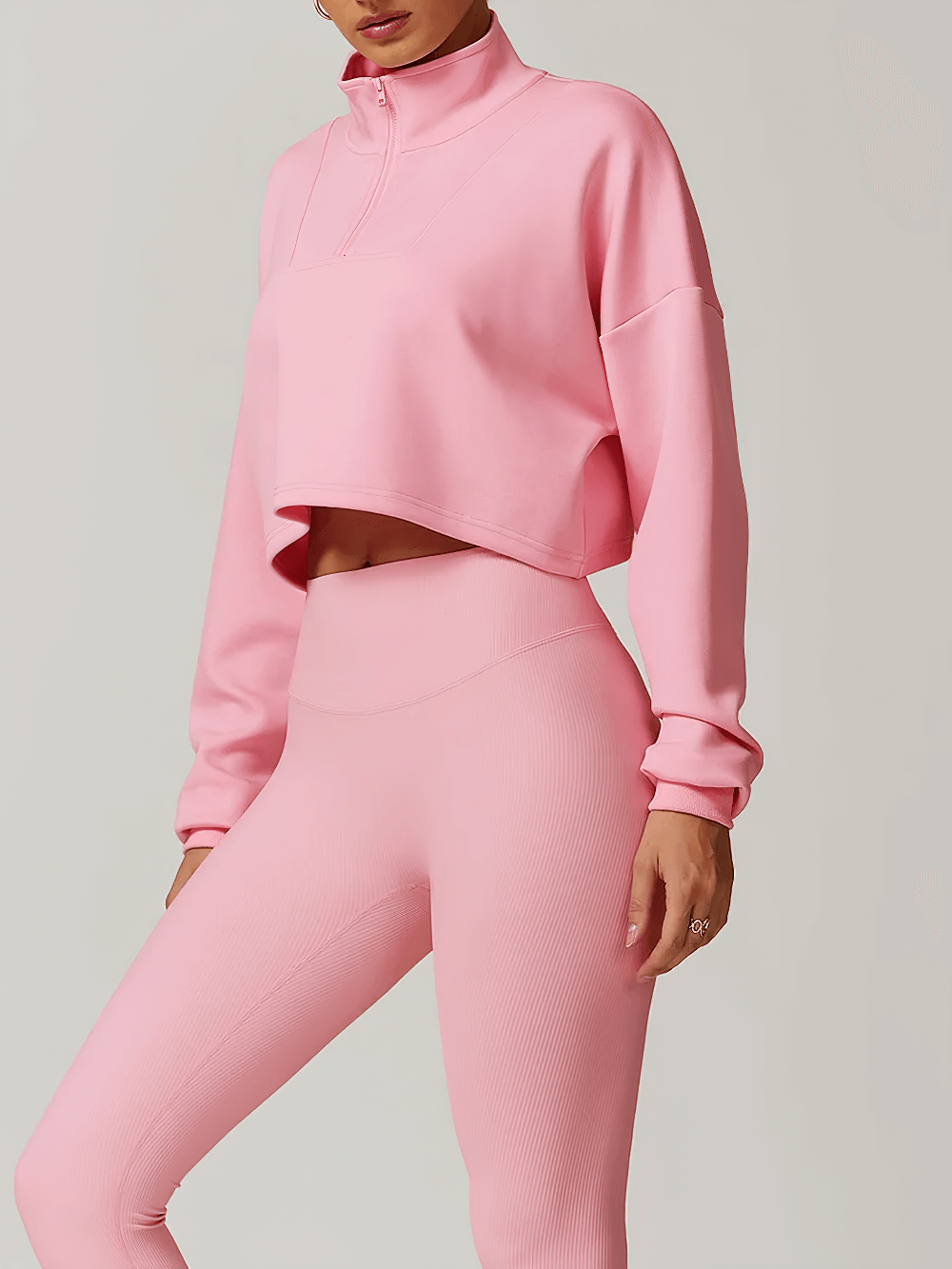 Pink cropped zip-up loose sweatshirt for women, perfect for activewear and layering, featuring a trendy half-zip and relaxed fit.