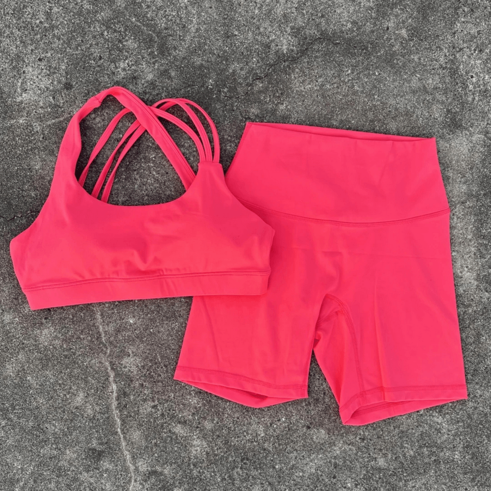 Alt Tag: Cross Back Yoga Bra and High Waist Gym Shorts Set - SF4355 in hot pink, cross-back sports bra with high-waist shorts on gray surface