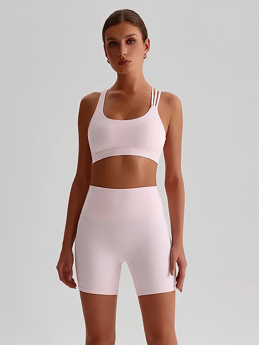 Alt Tag: Cross Back Yoga Bra and High Waist Gym Shorts Set - SF4355 on model, solid color tight-fit sports bra with high waist biker shorts