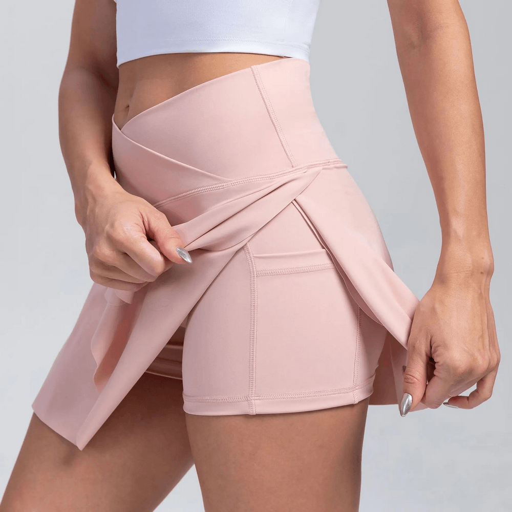 Alt Tag: Crossover High Waist Golf Skirt with Pocket - SF4439 blush pink pleated skort with inner shorts and side pocket, stretchy active fit