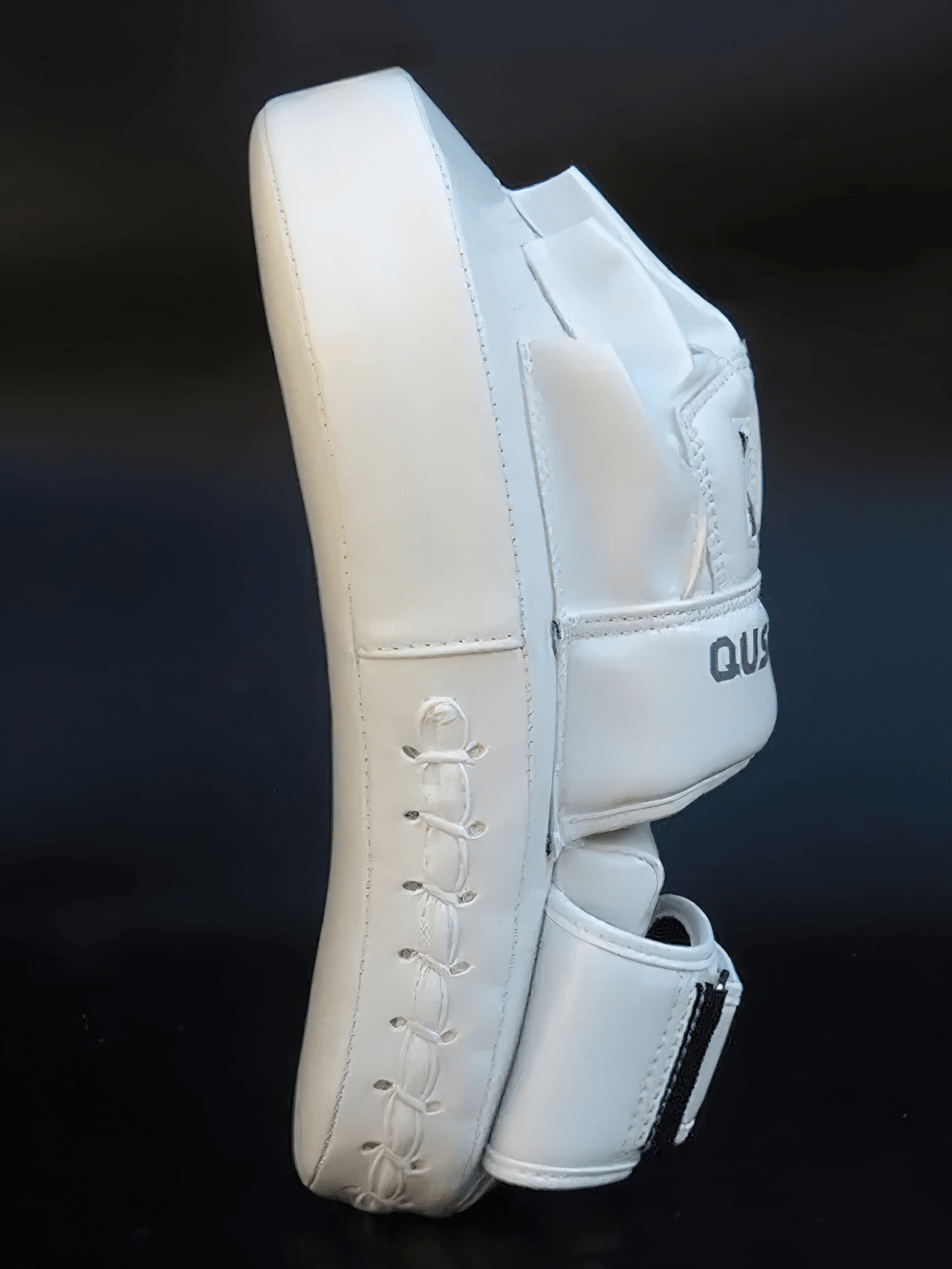 Curved PU leather boxing focus pad for training, side view with reinforced stitching, ideal for boxing and kickboxing drills.