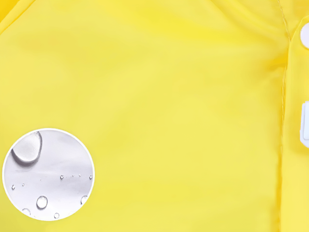 Close-up of Cute Animal Hooded Waterproof Raincoat with Pockets - SF3616 in bright yellow, showing waterproof material and button detail.