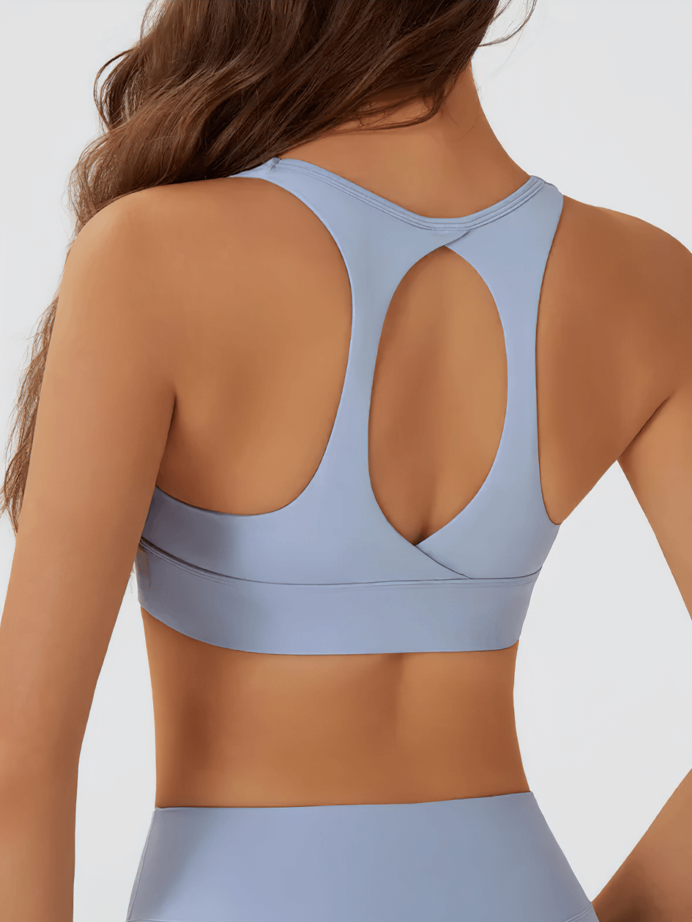 Model wearing Cutout Racerback Sports Bra With Removable Pads - SF4028, featuring stylish crossback design and breathable fabric.