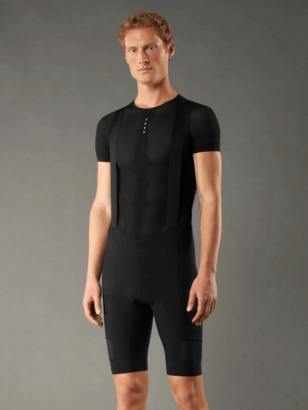 Model wearing men's breathable cycling bib shorts with 3D shockproof sponge pad and ergonomic design for road cycling.