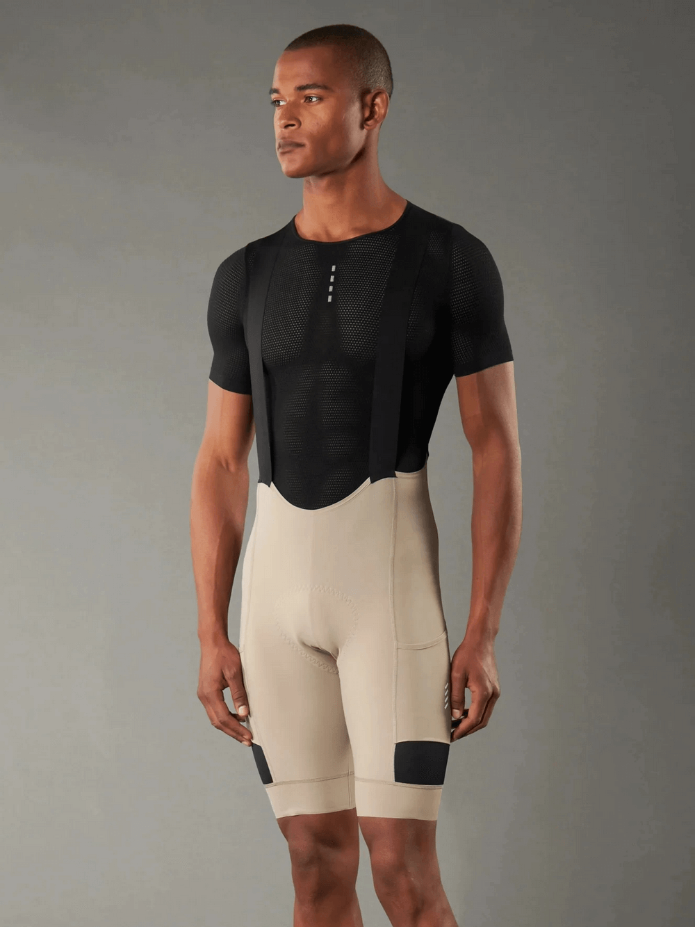 Cyclist wearing Men's Cycling Bib Shorts with 3D shockproof sponge pad, breathable fabric, and ergonomic design for road biking.