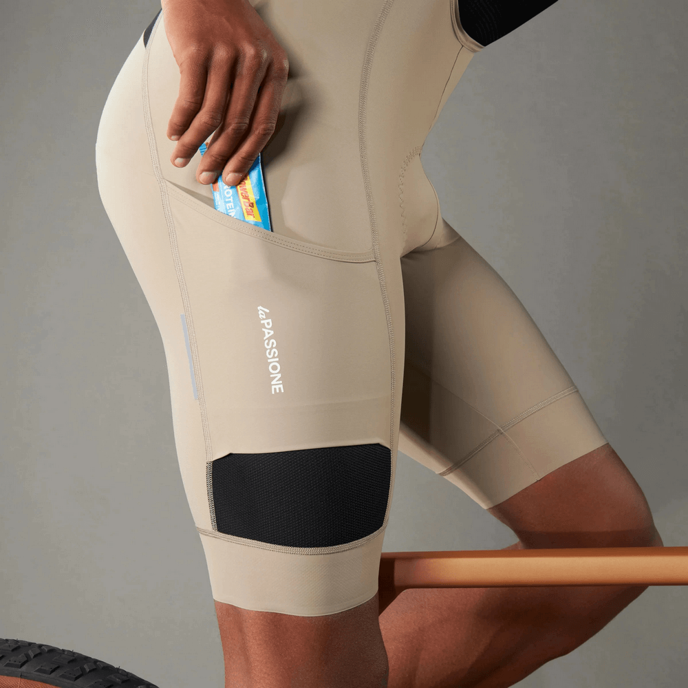 Men's cycling bib shorts with side pocket and 3D shockproof sponge pad, ideal for performance and road cycling, shown in use.