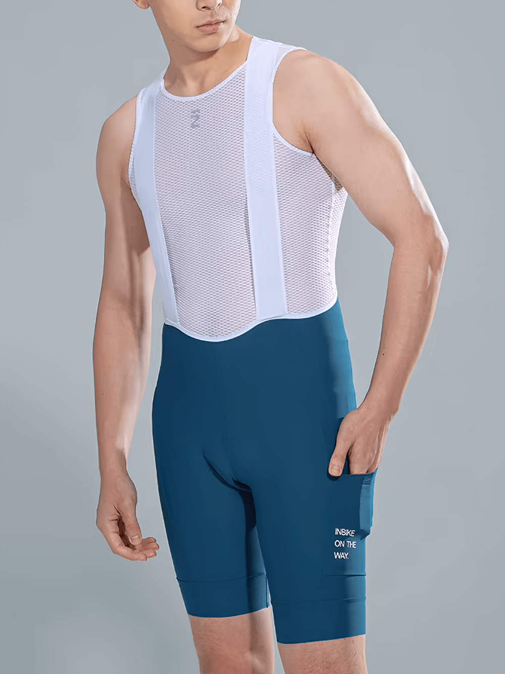 Man wearing blue cycling bib shorts with ergonomic padding and side pockets, designed for comfort and performance on long rides.