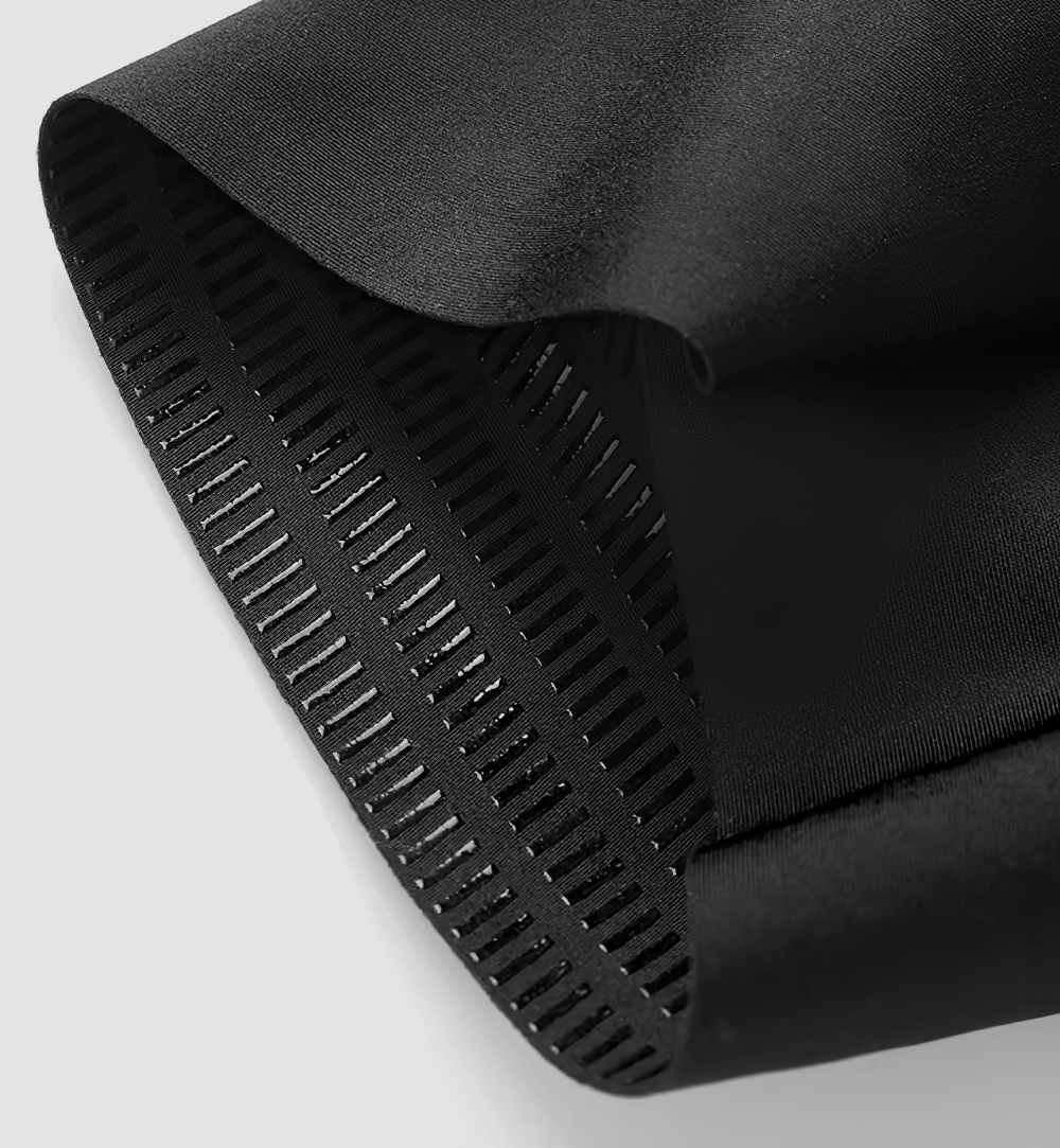 Close-up of black cycling bib shorts hem featuring durable elastic and sleek design for optimal cycling performance.