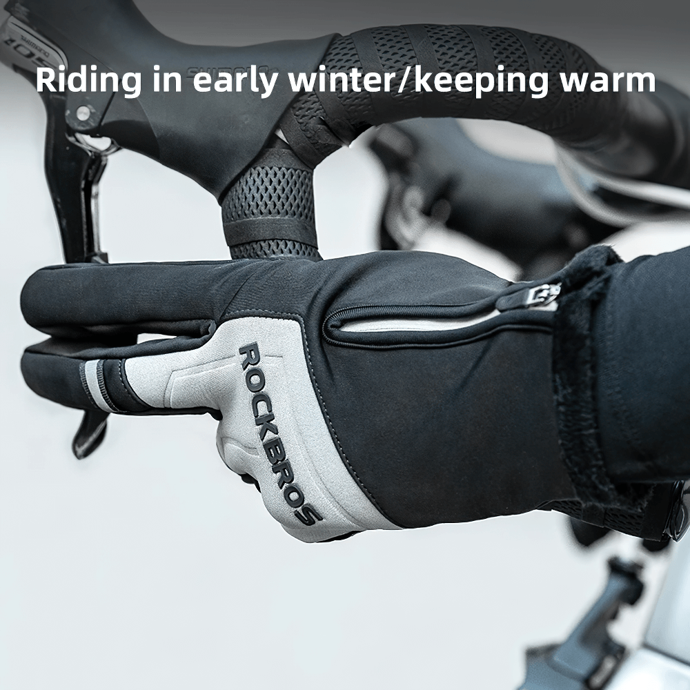 Full-finger cycling gloves gripping bicycle handlebar, featuring touchscreen compatibility and anti-slip design for cold-weather rides.