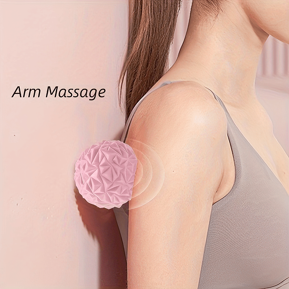 Woman using pink textured massage ball on arm for deep tissue relief and muscle relaxation.