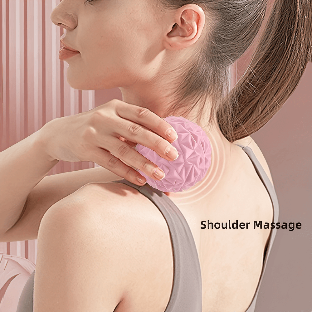 Woman using textured massage ball for shoulder muscle relief and tension release.