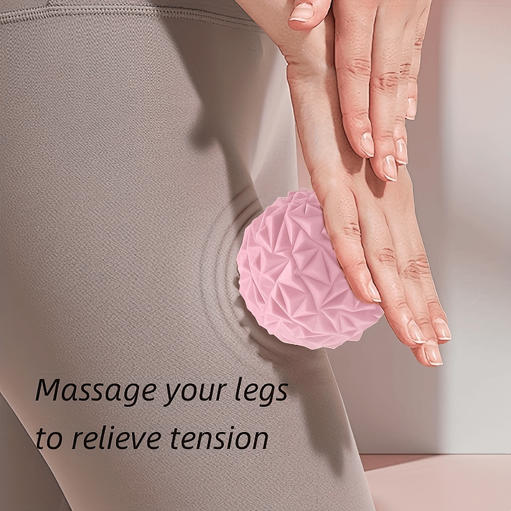 Pink textured massage ball massaging leg for muscle relief