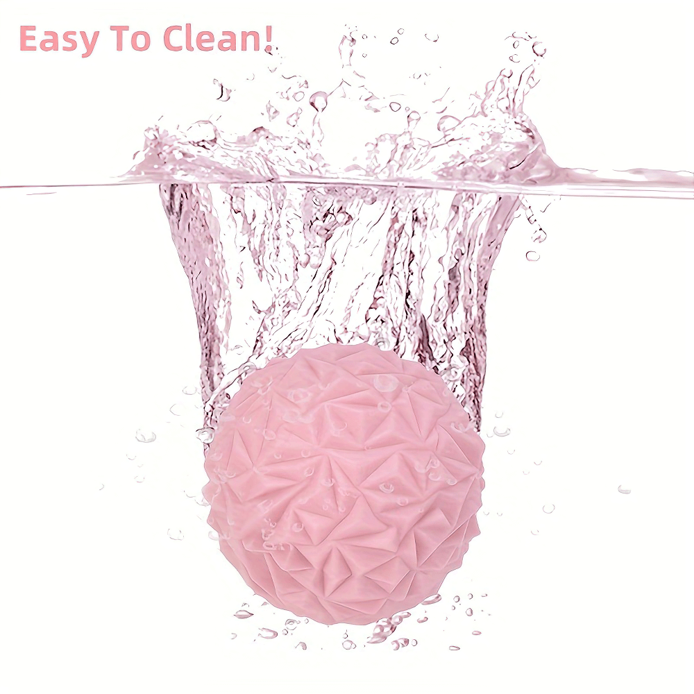 Deep tissue massage ball submerged in water, highlighting its easy-to-clean feature and textured surface for effective muscle relief.