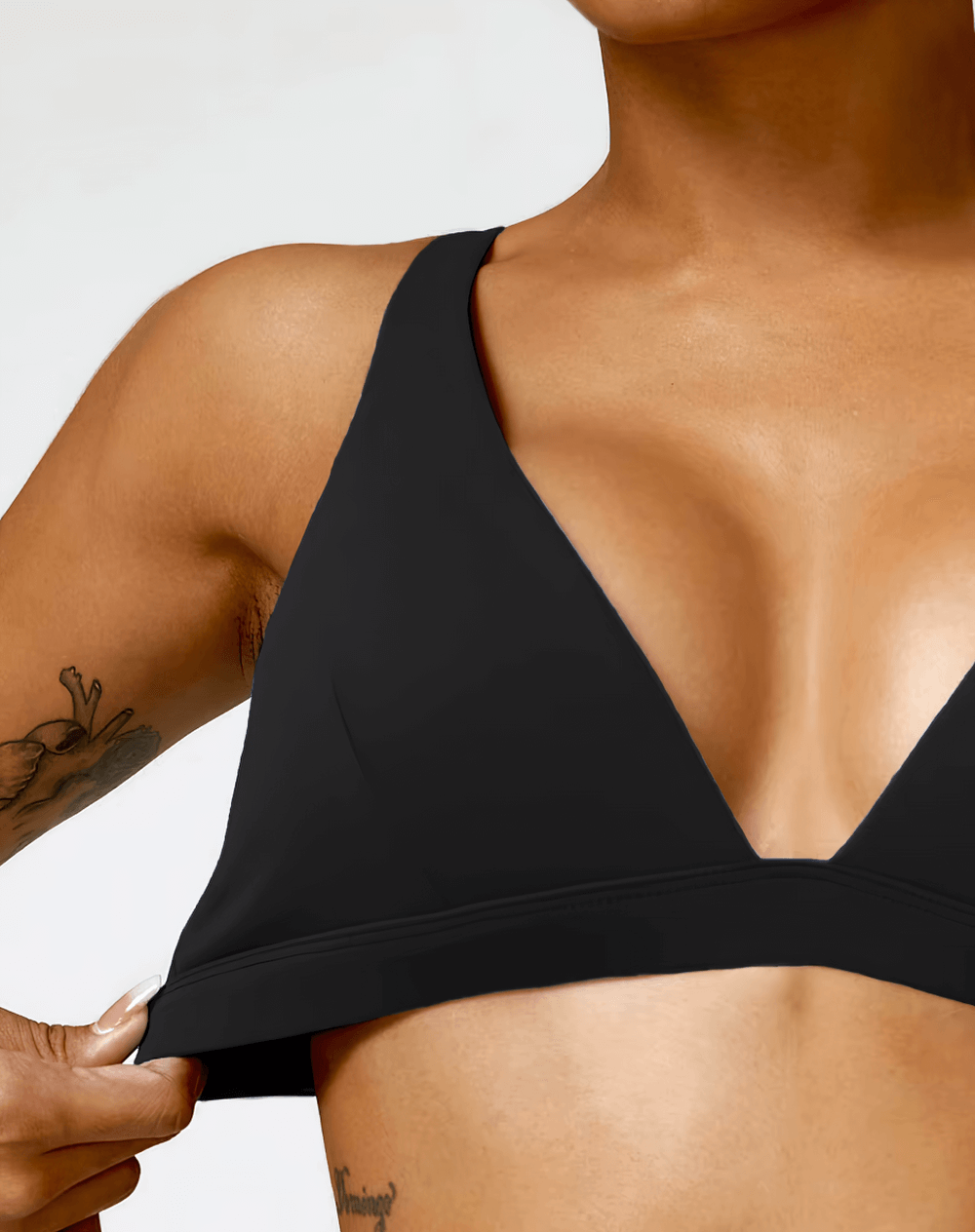 Deep V-neck padded sports bra for women, shockproof and supportive, in black. Ideal for fitness, running, and yoga workouts.