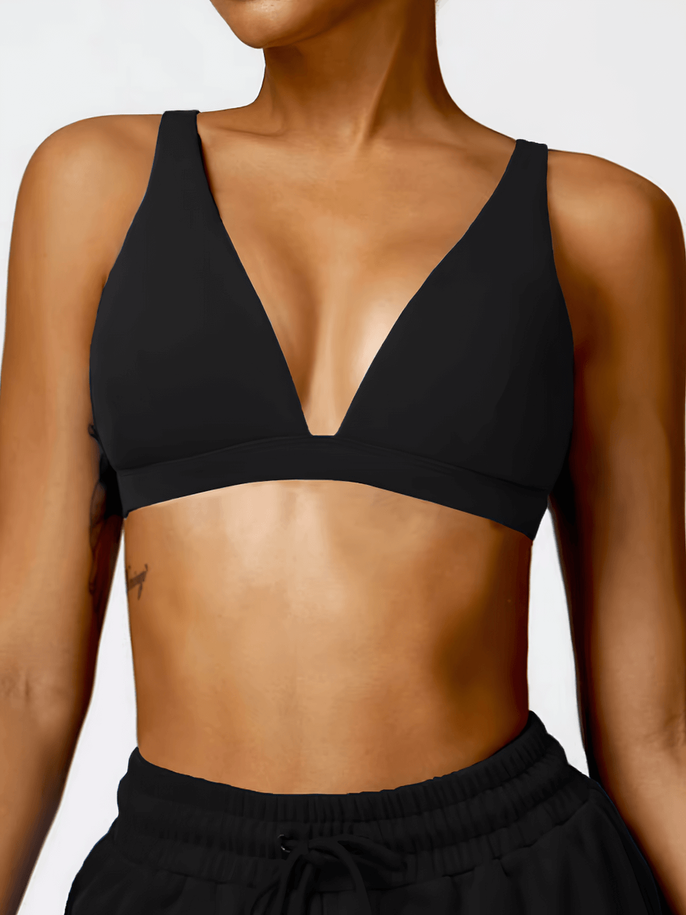 Deep V-neck padded sports bra in black for yoga and running, shockproof and breathable design for women’s fitness, style SF2461