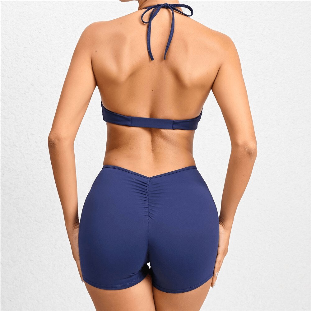 Back view of deep V-neck halter jumpsuit in navy blue, perfect for yoga and fitness. Comfortable, sleeveless design for women.