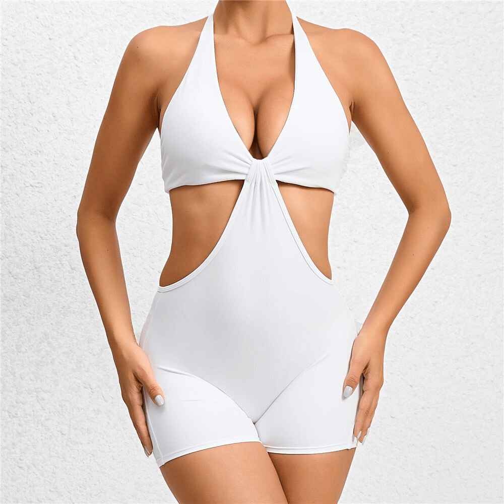 Woman wearing a white deep V-neck yoga halter jumpsuit romper, emphasizing style and comfort for fitness and yoga practice.