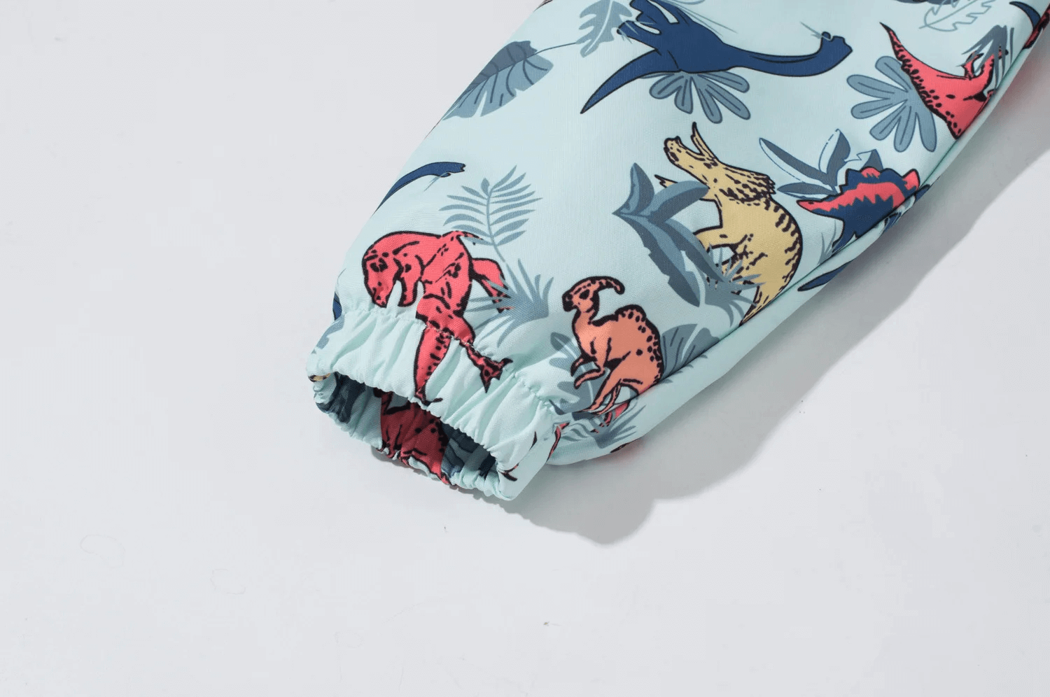 Close-up of Dinosaur Print Kids Waterproof Jacket with Hood - SF3577, featuring colorful dinosaur designs on waterproof fabric sleeve.