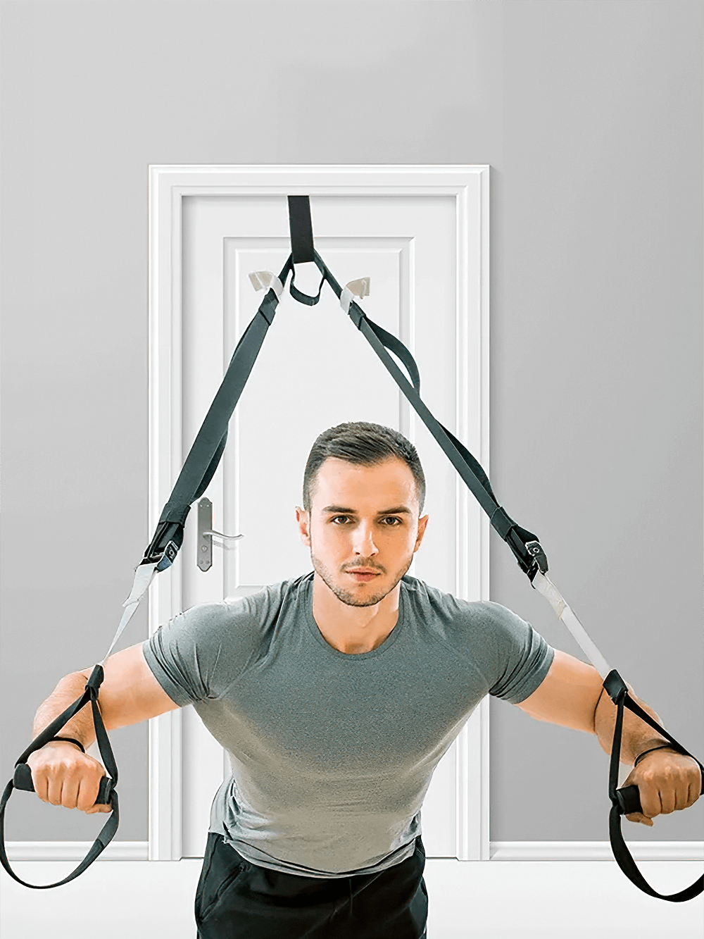 Man using resistance band door anchor SF3340 for home workout. Ideal for muscle toning and strength training. Foam stopper protects door.