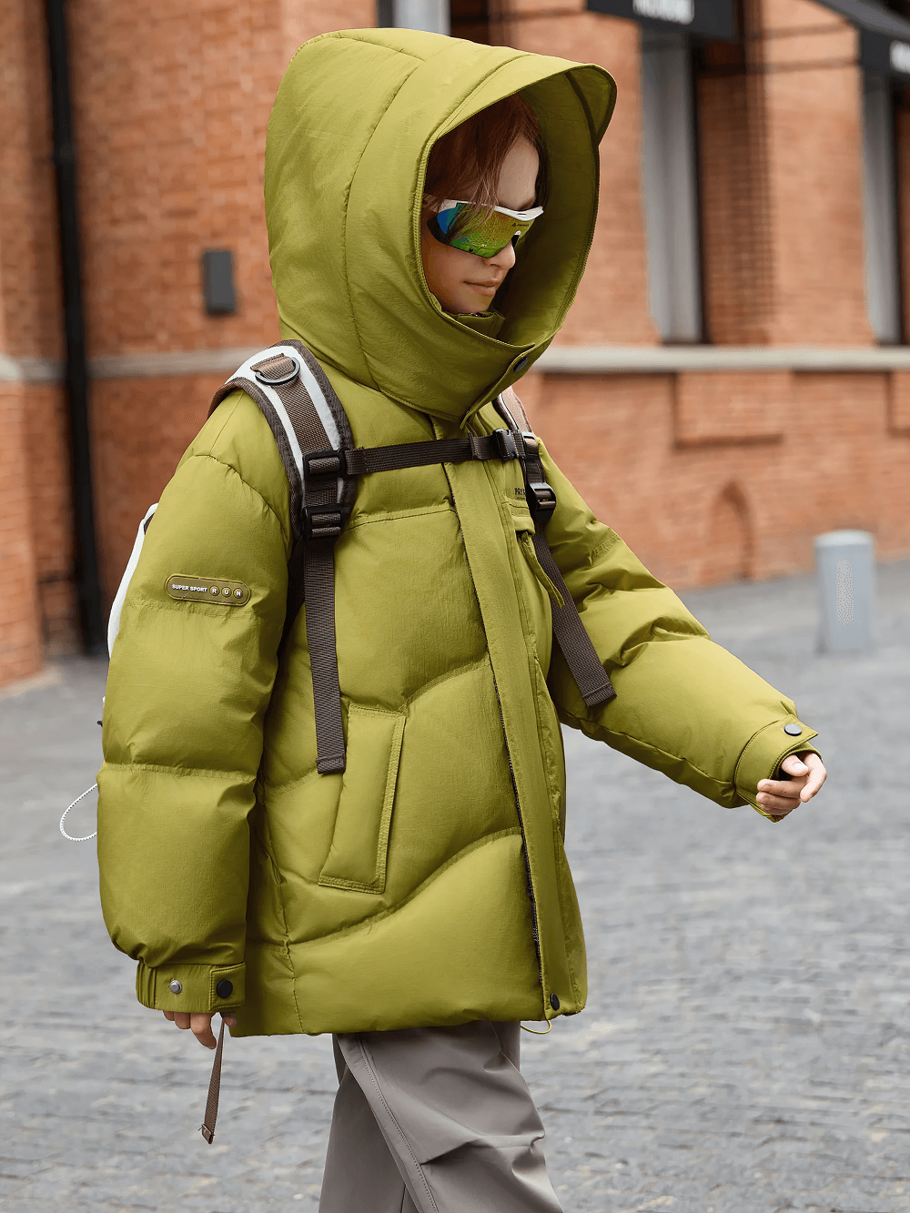 Child wearing olive Down Jacket with Hood and Warm Padding - SF3627 walking outdoors, showcasing detachable hood and elastic cuffs.