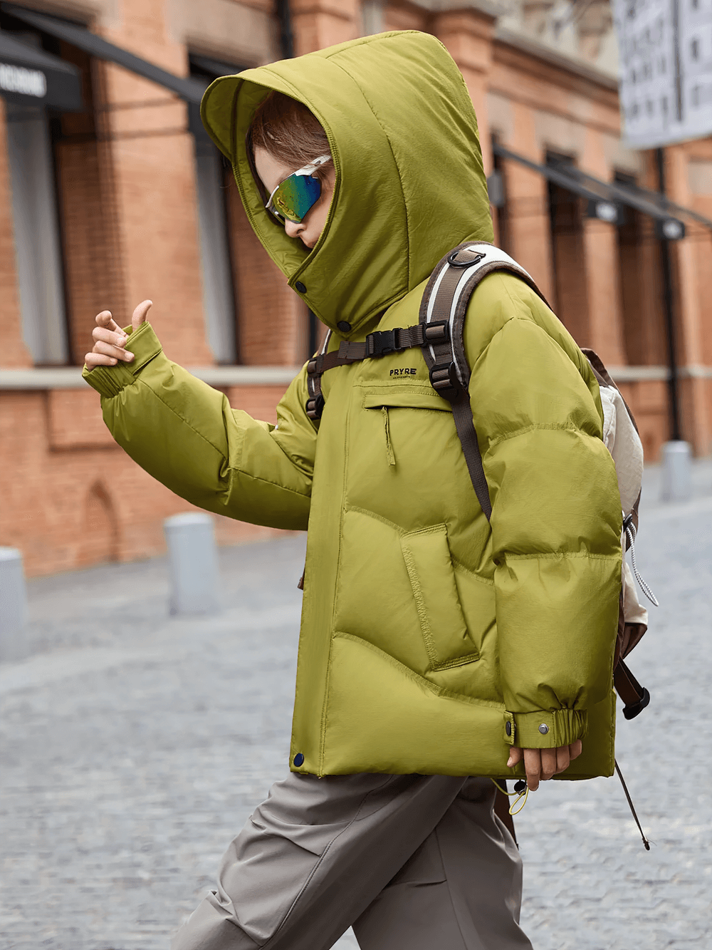 Child wearing Down Jacket with Hood and Warm Padding - SF3627 in olive, ideal for cold weather and outdoor activities, walking stylishly.