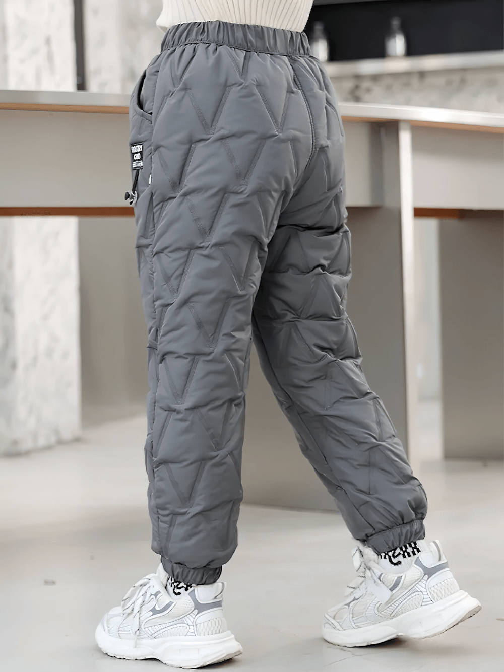 Child wearing Down Pants Warm Padded Ski and Snow Trousers - SF3733 in gray, showcasing insulated comfort for winter activities.