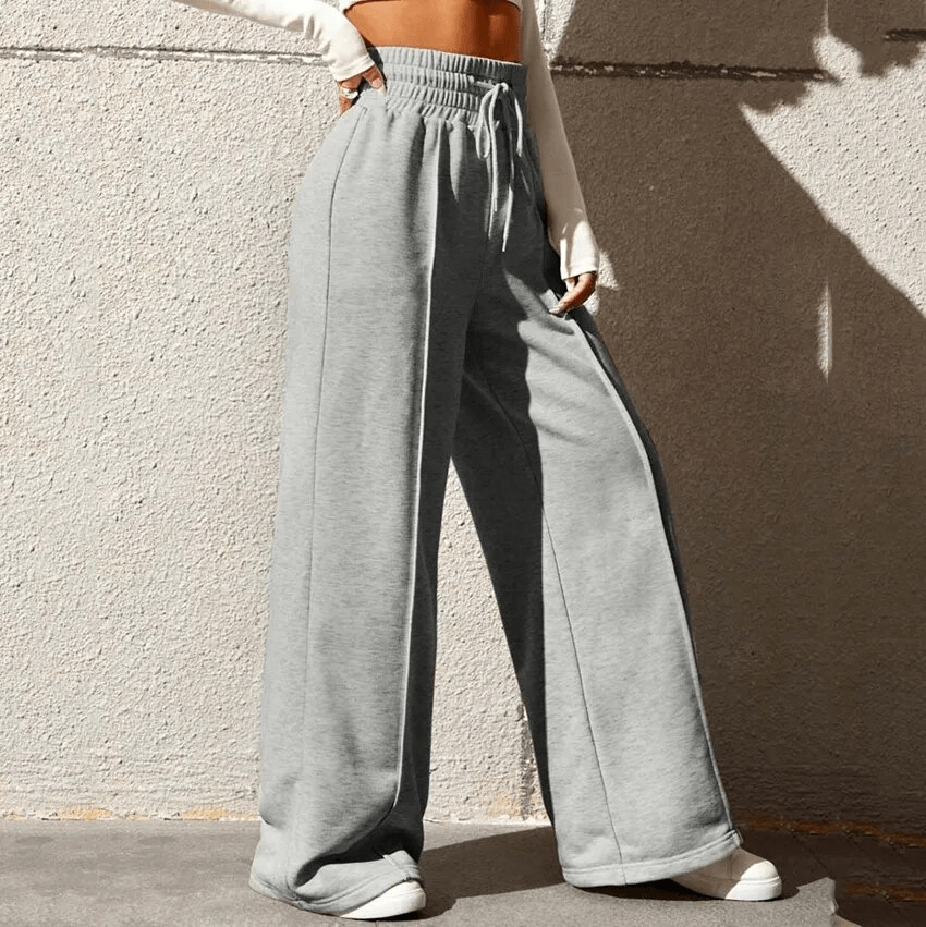 Woman wearing gray drawstring pleated wide leg straight pants with high waist and loose fit, perfect for stylish comfort.