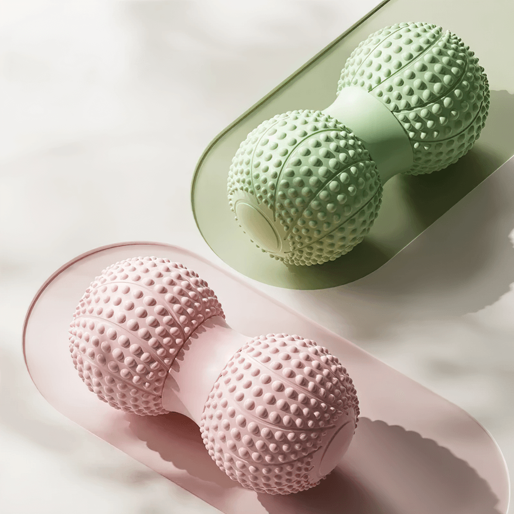 Dual-sided massage rollers in pink and green for muscle relaxation and therapy.