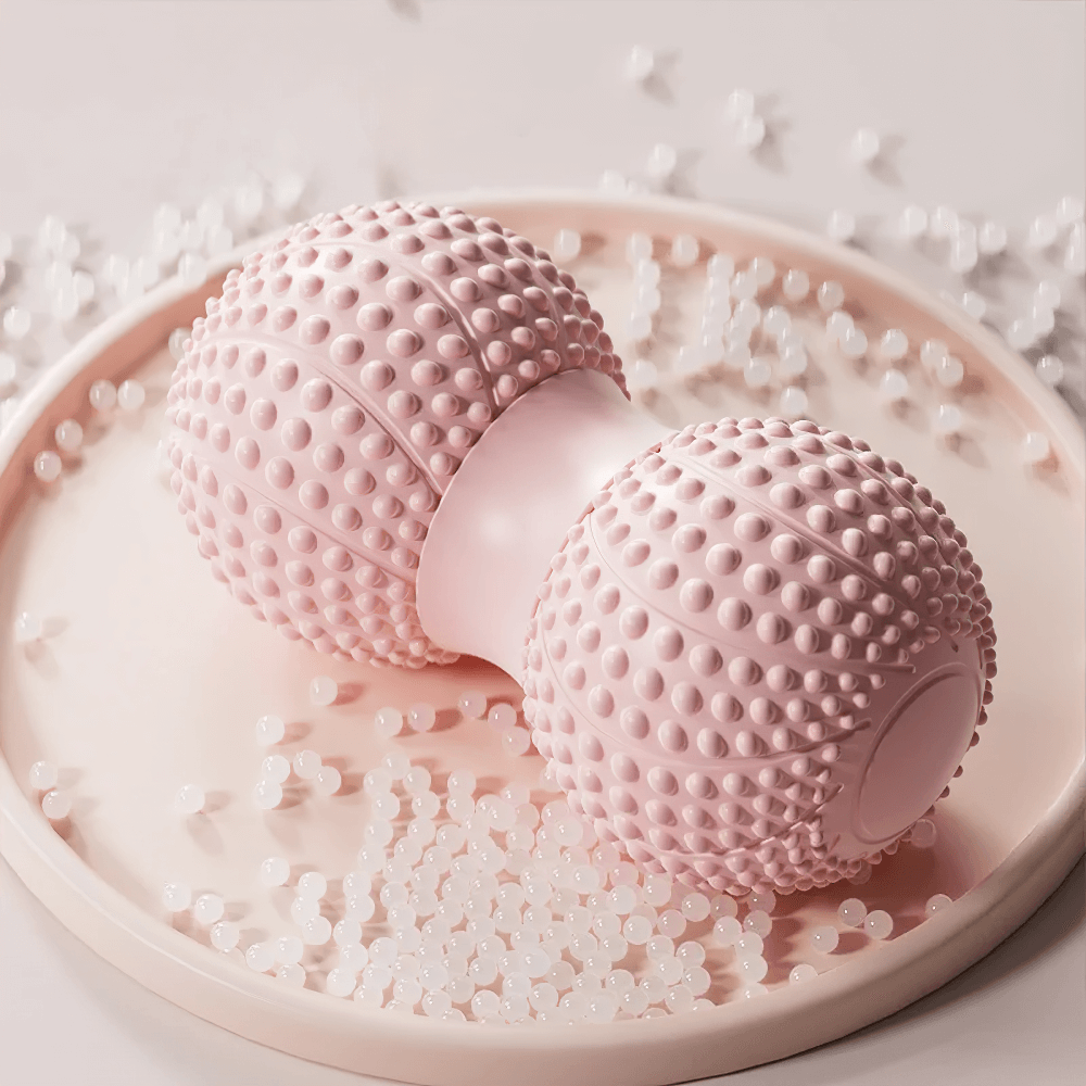Dual-sided pink massage roller for muscle relaxation, featuring textured surfaces for back, arm, and foot therapy.