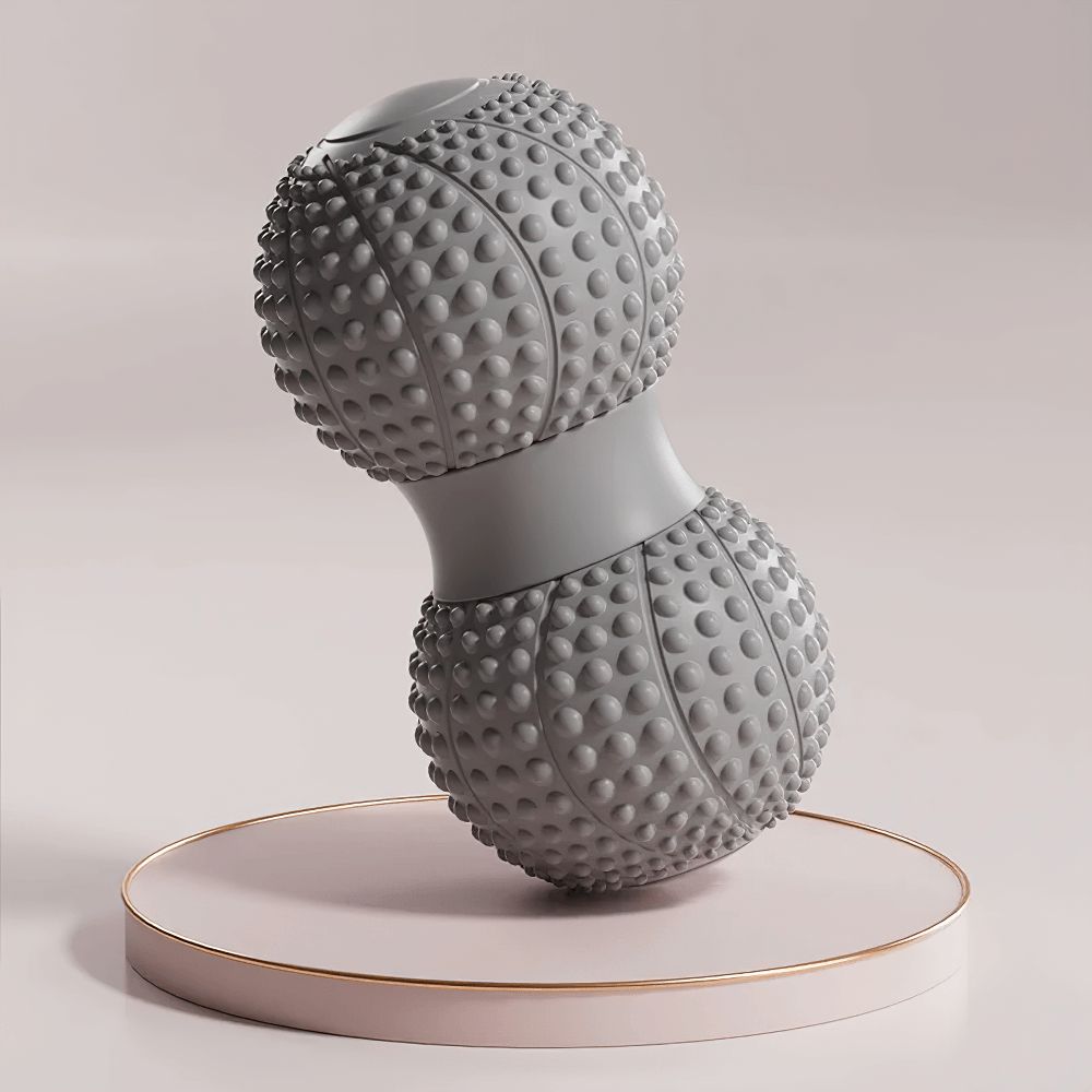 Grey dual-sided massage roller with textured surface for muscle relaxation, displayed on a stylish platform