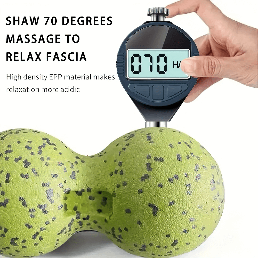Dual-sphere massage ball in green with a digital hardness tester displaying 70 degrees for optimal fascia relaxation.