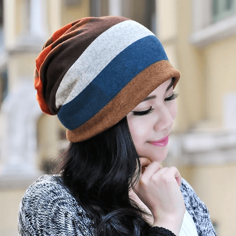 Woman wearing a stylish dual-use beanie with stripes, ideal for both warmth and fashion. Crafted from soft polyester, perfect for any look.