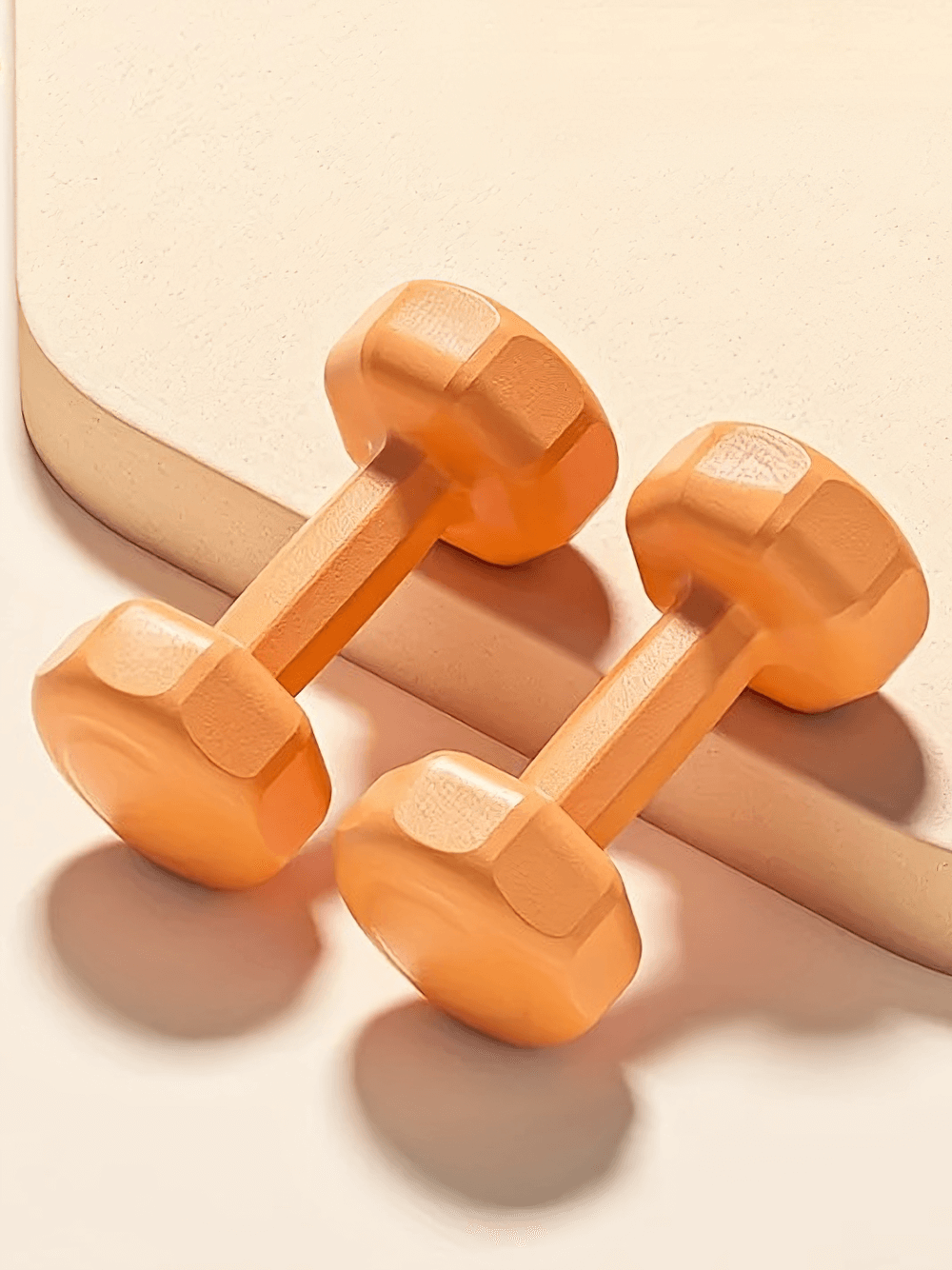 Orange 4.4lb dumbbell set for workouts, strength training, and yoga, featuring durable design and secure grip for home or gym use.