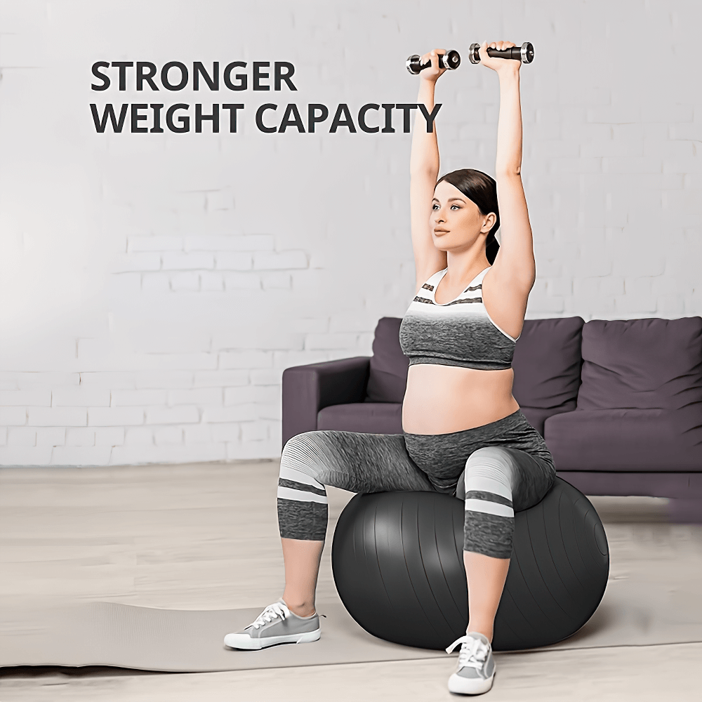 Woman sitting on anti-burst ball doing arm exercises with dumbbells in a home setting.