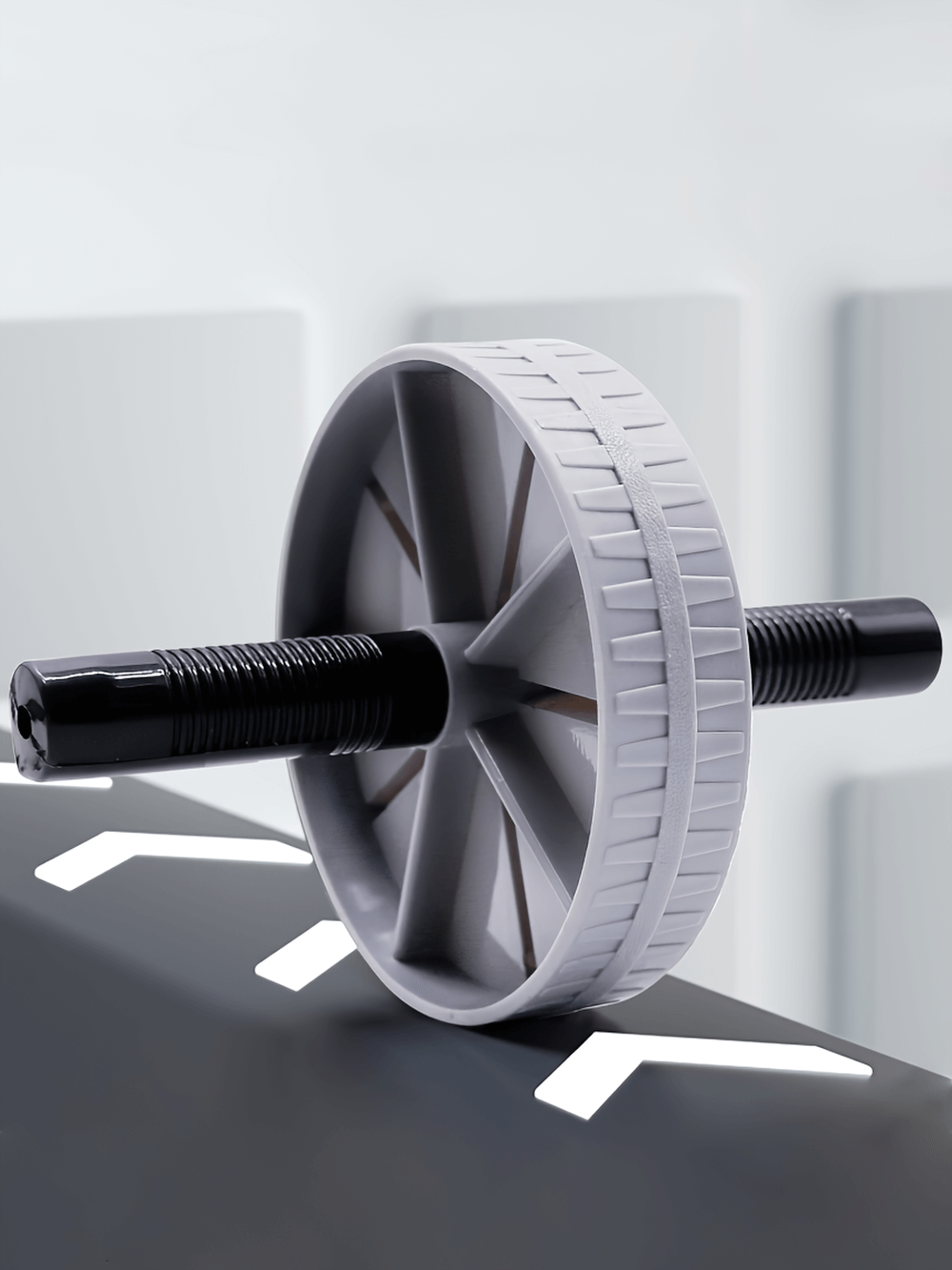 Sleek gray and black ab roller wheel SF2796 enhancing core strength at home or gym, made from durable ABS material with ergonomic handles.