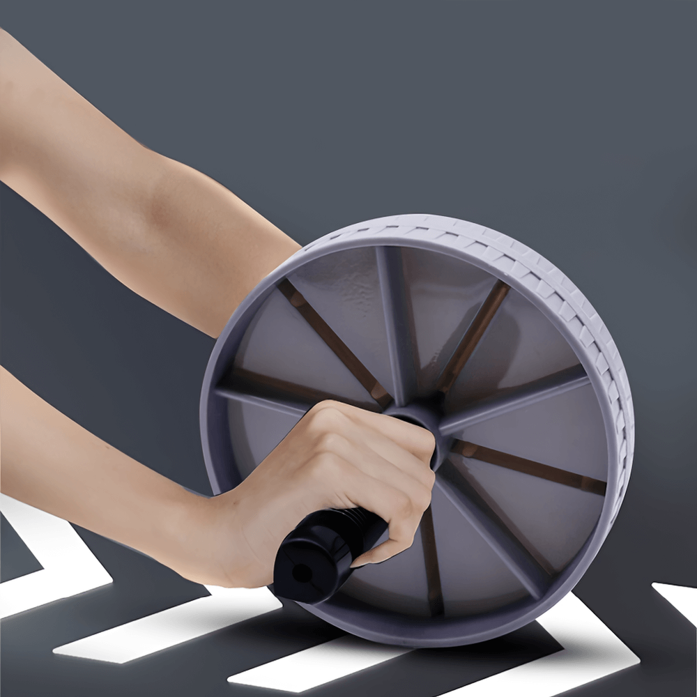 Close-up of gray and black ab roller wheel being used for workout, showcasing durable ABS design and ergonomic handle for grip.