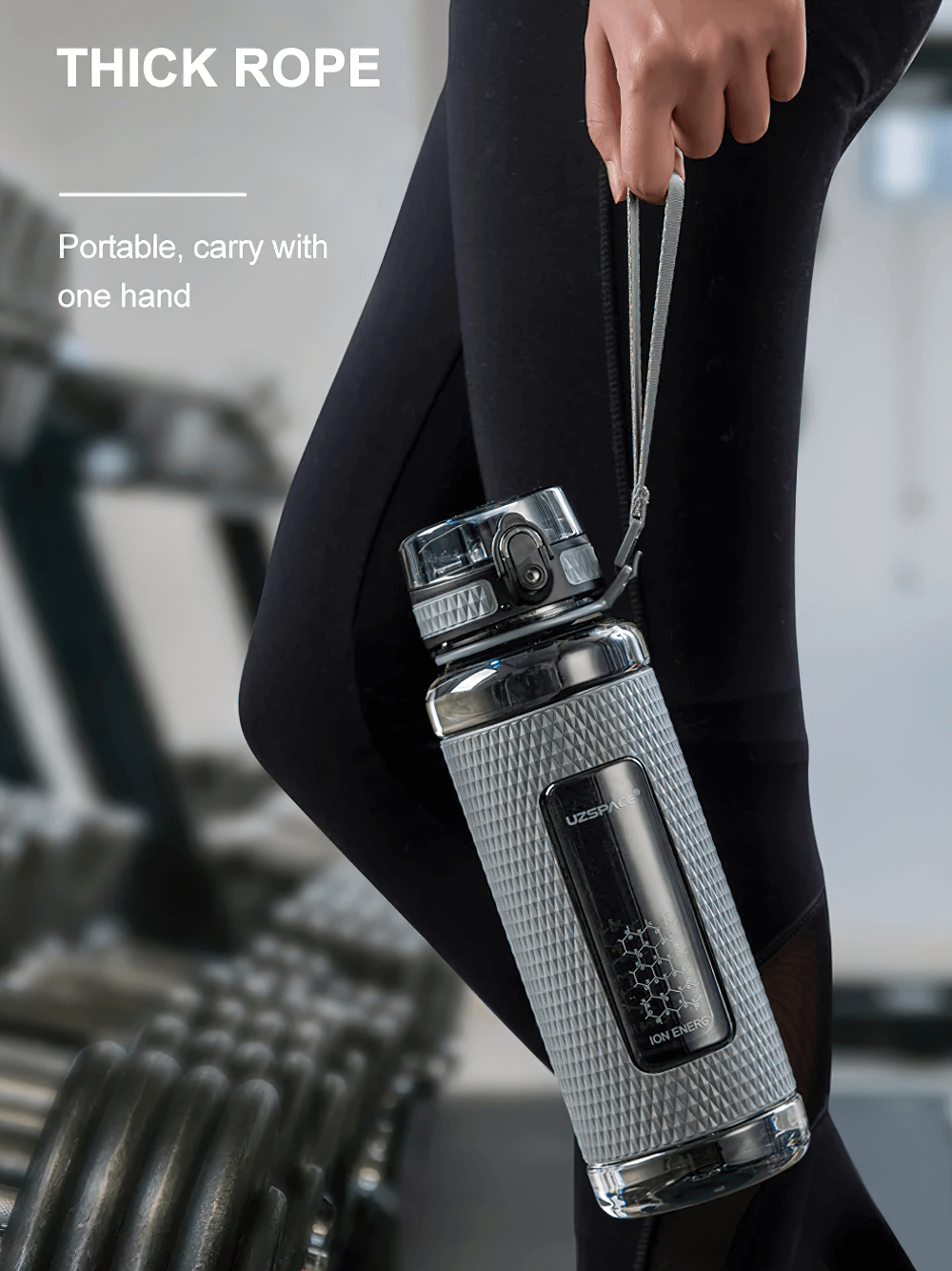 Person holding a durable, leak-proof sports water bottle with handle, highlighting its one-handed open feature for easy portability.