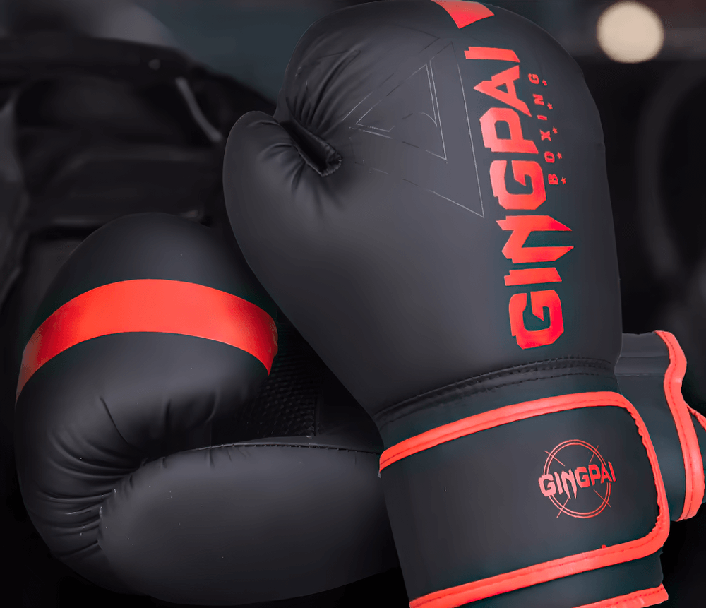 Durable PU leather boxing gloves for training with red accents, featuring secure wrist straps for enhanced support and ventilation.
