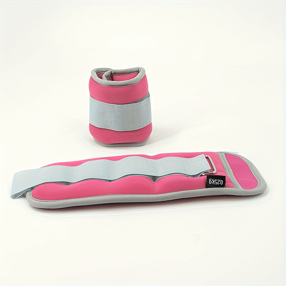 Pink and gray adjustable ankle and wrist weights set, ideal for running and strength training, featuring secure straps for a snug fit.