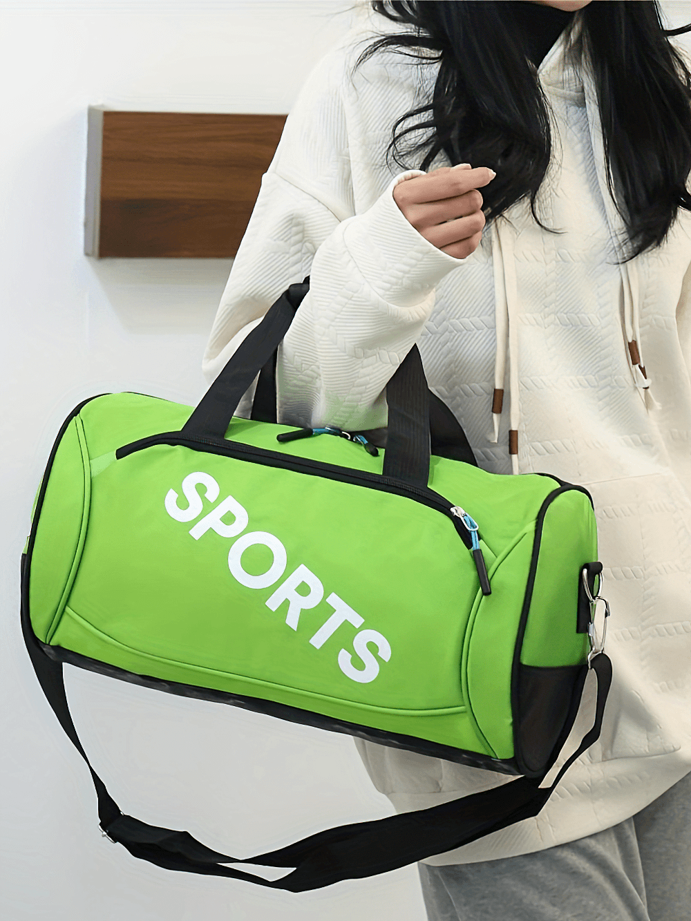 Green Oxford fabric duffel bag with 'SPORTS' print, secure zipper, and adjustable strap. Ideal for gym, yoga, and travel.