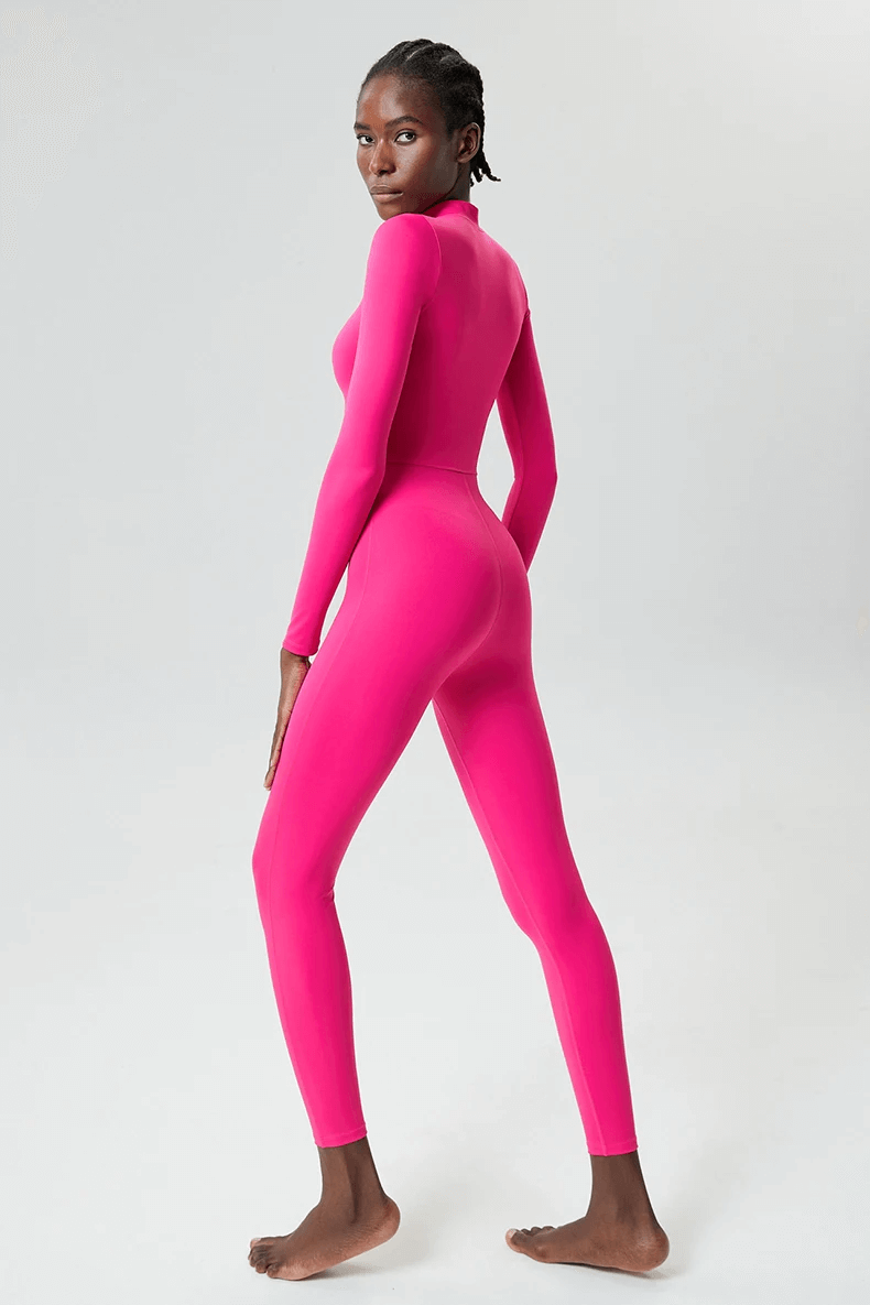 Woman wearing pink dynamic long sleeves jumpsuit for yoga and gym, SF2082, showcasing sleek design and snug fit