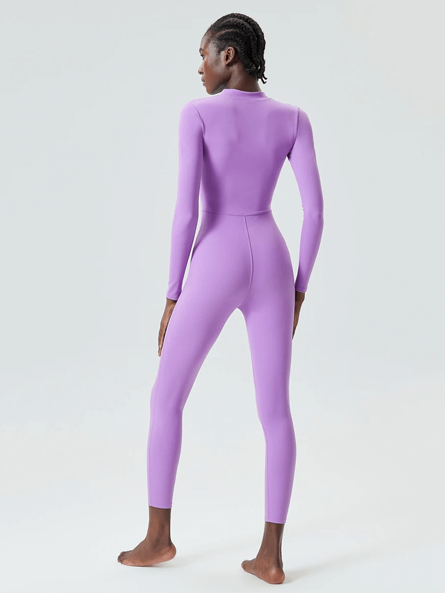 Back view of a purple long sleeve jumpsuit for yoga and gym, showcasing its sleek fit and stretchy fabric blend for active wear.