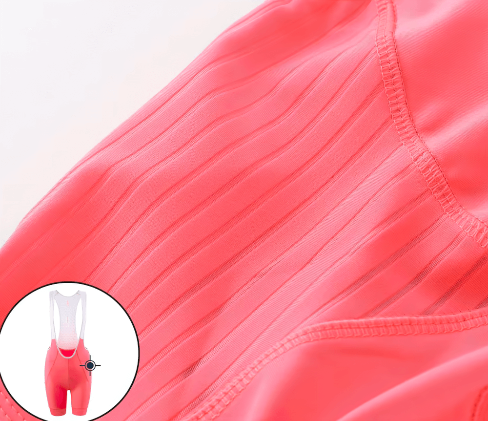 Close-up of fluorescent women's cycling bib shorts, elastic and breathable, ideal for performance rides, featuring ergonomic design.